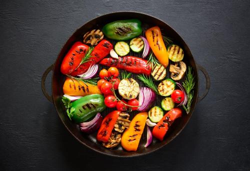 a pan filled with different types of vegetables on a table at Hotel Restaurant Rössli in Schönenberg