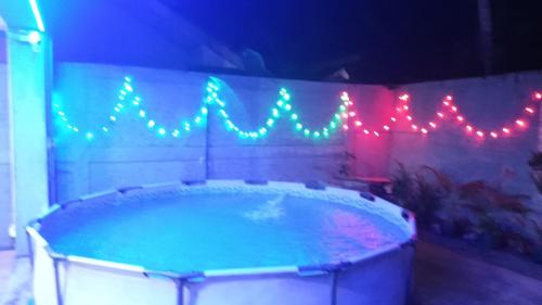 a hot tub with christmas lights on a wall at This Is It Airport Hotel and Restaurant in Negombo