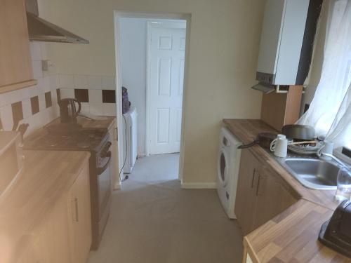 a kitchen with a sink and a washing machine at UNIVERSITY HOMES in Middlesbrough