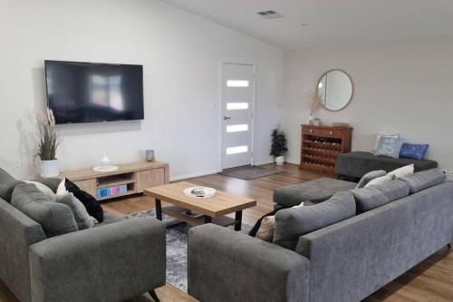 a living room with two couches and a tv at Wellington marina70 in Wellington East