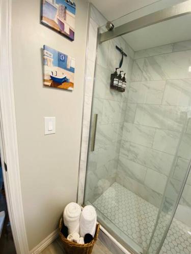 a bathroom with a shower and a basket of towels at Serenity Guest Suite in Pocatello in Pocatello