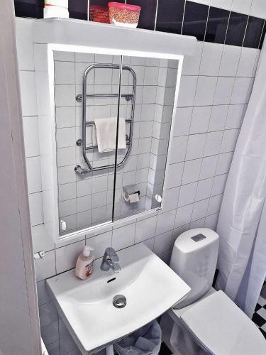a white bathroom with a sink and a toilet at City Apartments Triangeln in Malmö