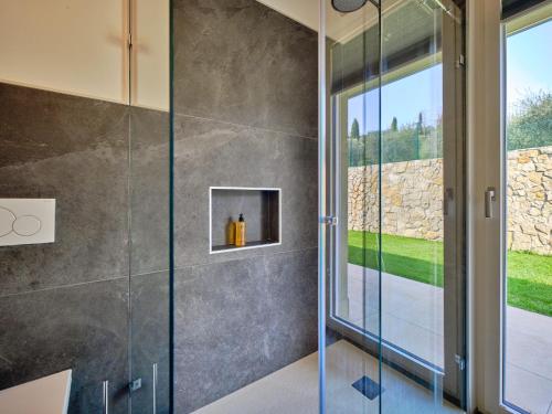 a shower with a glass door in a bathroom at Villa Sunny Lake Suites in Bardolino