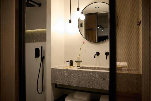 a bathroom with a sink and a mirror at InnAthens in Athens