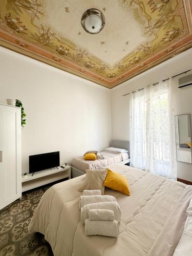 a bedroom with two beds and a coffered ceiling at Sant'Oliva28 in Palermo