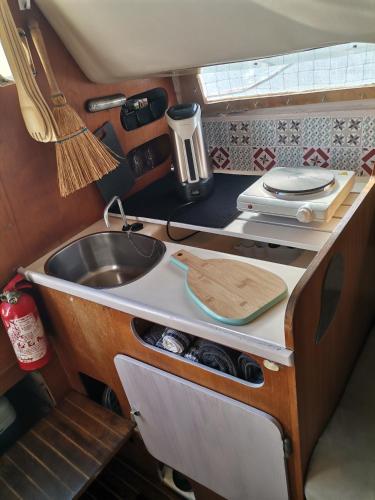 an rv kitchen with a sink and a counter at Voilier en bord de mer 55€ par nuit in Marseillan