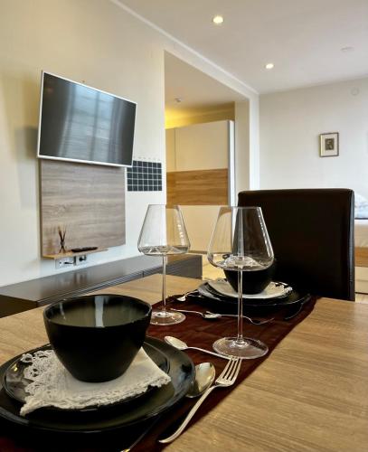 a dining room table with two glasses and a bowl at VENEZIANA Boutique Hotel Superior in Koper