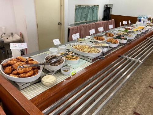 a buffet line with many different types of food at Hotel Alpha-One Miyakonojo in Miyakonozyō