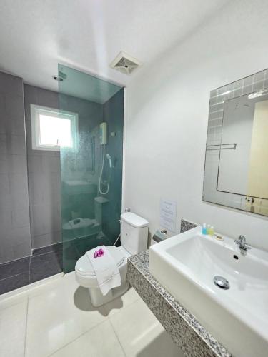 a bathroom with a toilet and a sink and a shower at La Xenia Hotel Kata Beach in Kata Beach