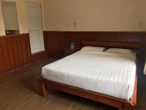 Säng eller sängar i ett rum på Hotel Suva