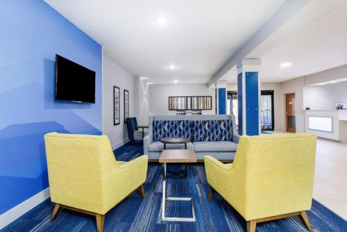 a living room with two chairs and a couch at Holiday Inn Express & Suites Jacksonville - Atlantic Beach by IHG in Jacksonville