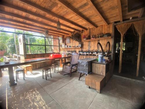 a kitchen with a bar and chairs in a cabin at Cat Canh Farm in Ho Chi Minh City