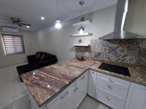 a kitchen with a counter top and a stove at Departamentos Ada's in Puerto Peñasco
