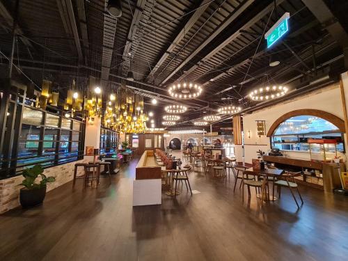 a restaurant with tables and chairs and chandeliers at qTownPad in Queenstown