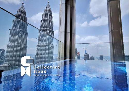 a view of the petronas twin skyscrapers from the observation deck at Tropicana Residence Kuala Lumpur by Collective Haus in Kuala Lumpur