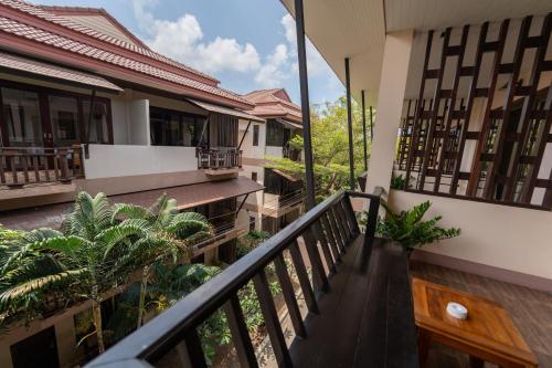 a balcony of a house with trees and plants at Wind Beach Resort in Koh Tao