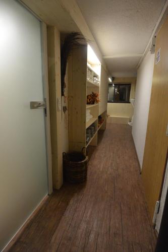 an empty hallway of a room with a hard wood floor at Haus Erli in Mittenwald