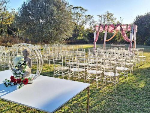 a white table with chairs and an arch in a field at 170 On Runnymead in Chartwell