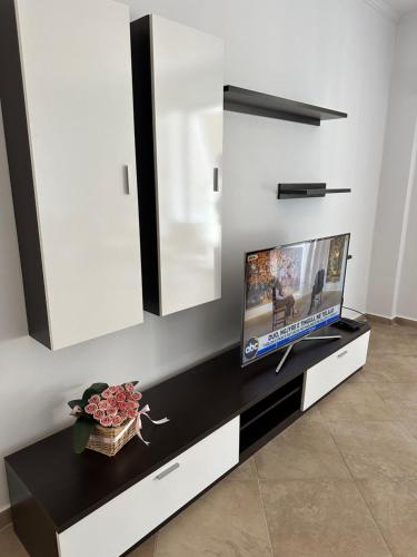 a living room with a flat screen tv on a counter at ViaSaranda By ShqipTrip in Sarandë