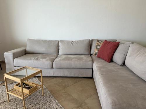 a living room with a couch and a table at ViaSaranda By ShqipTrip in Sarandë