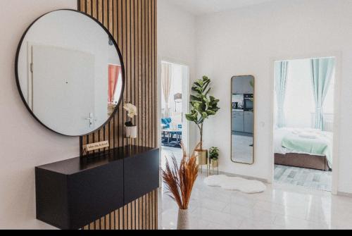 a living room with a mirror and a bedroom at Ferienwohnung Zentrum Erding in Erding