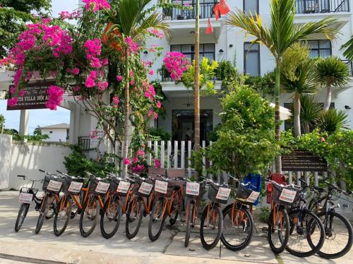 a row of bikes parked in front of a building at Santa Sea Villa in Hoi An