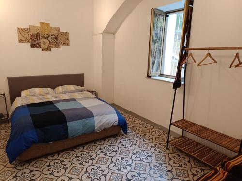 a bedroom with a bed and a window at Casa vacanze Maison Zio Bruno A' Scalinatella in Naples