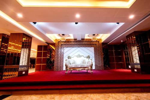 a room with a bed on a red carpet at HOTEL VRINDAVAN in Bīrganj