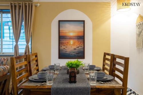 a dining room with a table with plates and glasses at EKOSTAY - Omega Villa in Igatpuri