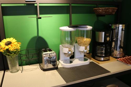 a counter with two blenders and a blender on it at Amman Trail Hostel in Amman