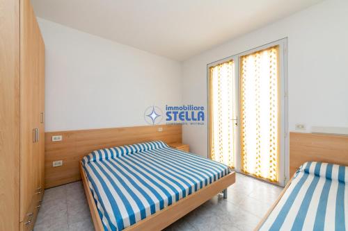 a bedroom with two beds and a window at Residence Adriatica in Lido di Jesolo