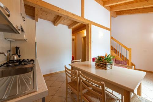 a kitchen with a table and a stove at Family Wellness Camping al Sole in Molina di Ledro