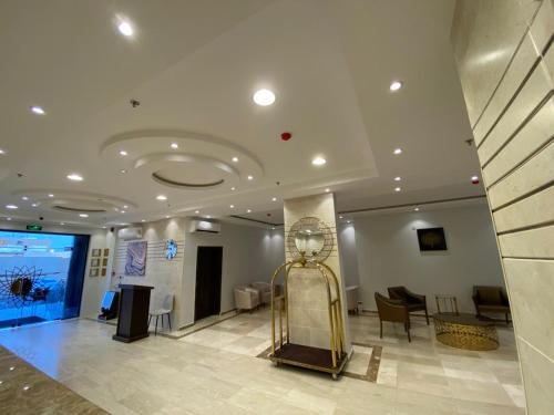 a lobby with a gold elevator in a building at Zmroud Al-Morouj in Yanbu