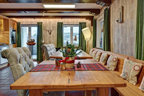 a living room with a wooden table and a couch at Allgäuer Panoramahotel in Oberstaufen