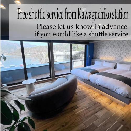 a bedroom with two beds and a large window at SAZANAMI LAKE FRONT in Fujikawaguchiko