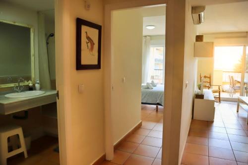 ein Bad mit einem Waschbecken und ein Zimmer mit einem Schlafzimmer in der Unterkunft Isla de Altea Sol Y Mar in Altea