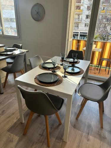 une salle à manger avec des tables et des chaises et une horloge dans l'établissement Your Apartment at Riviera Bliss, à Antibes