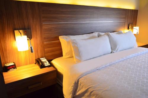 a hotel room with a bed and a telephone at Holiday Inn Express & Suites - Ciudad Obregon by IHG in Ciudad Obregón