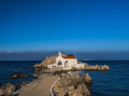 a small chapel on a rocky island in the ocean at Μεζονέτα AIKATERINI N 9 in Chios