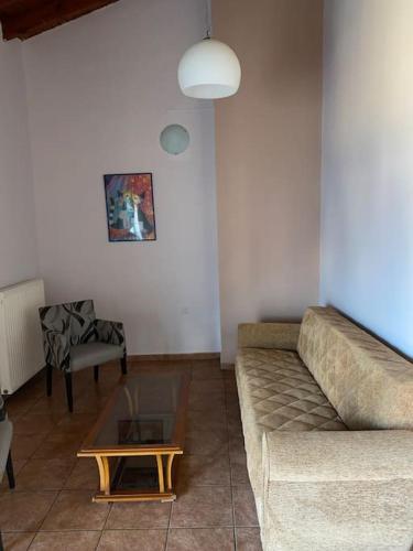 a living room with a couch and a coffee table at Μεζονέτα AIKATERINI N 9 in Chios