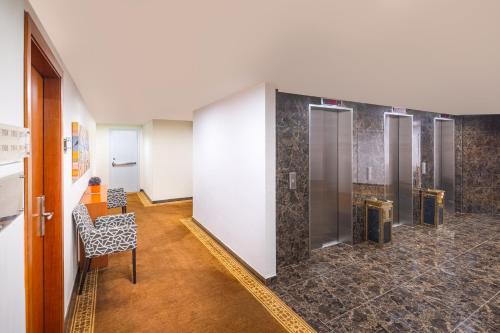 un couloir avec une rangée d'ascenseurs dans un bâtiment dans l'établissement Blue Coral Hotel, à La Mecque