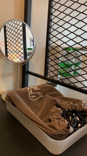 a bed with a blanket and a mirror on a table at Jeboutiquelangsuan hotel in Lang Suan