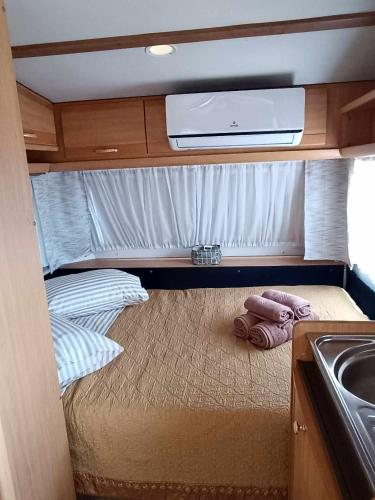 a small room with a bed in an rv at Fox Caravan in Afionas