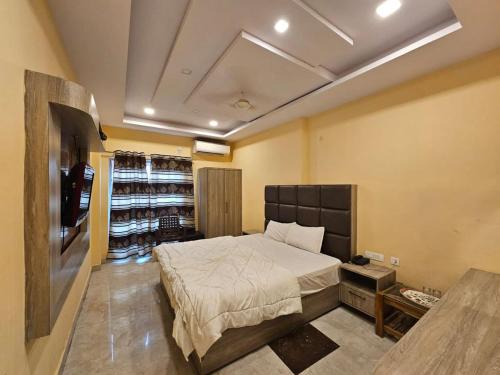 a bedroom with a bed and a wine cellar at Hotel Aditya Inn in Varanasi