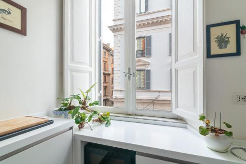 a window with a view of a city at Luxury apartment near via veneto in Rome