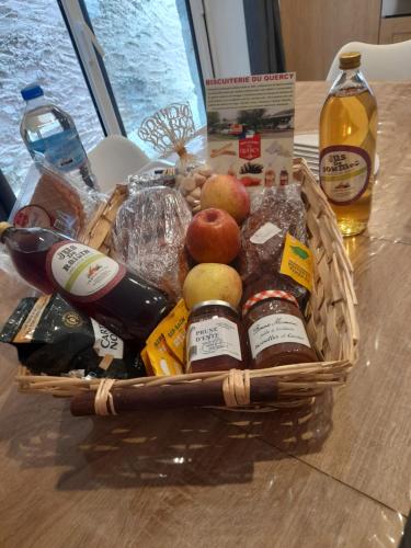 a basket of food and drinks on a table at gite de la tour in Montcuq