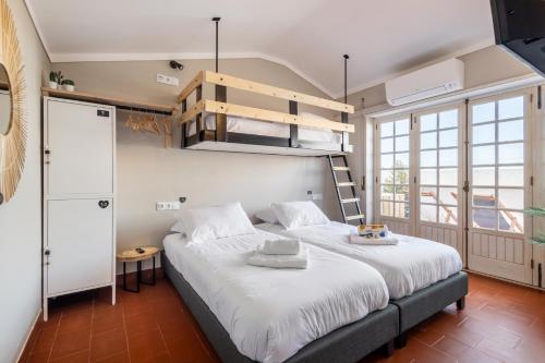 a bedroom with a bunk bed and a ladder at Santa, Sea & Sun in Santa Cruz