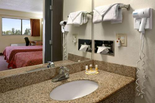 a bathroom with a sink in a hotel room at Days Inn by Wyndham Cloverdale Greencastle in Cloverdale
