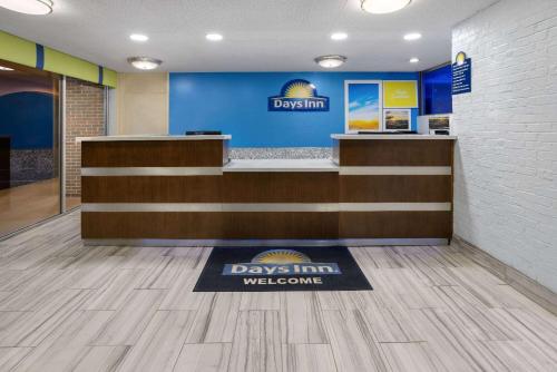 a lobby of a days inn welcome sign on a welcome mat at Days Inn by Wyndham Forsyth in Forsyth