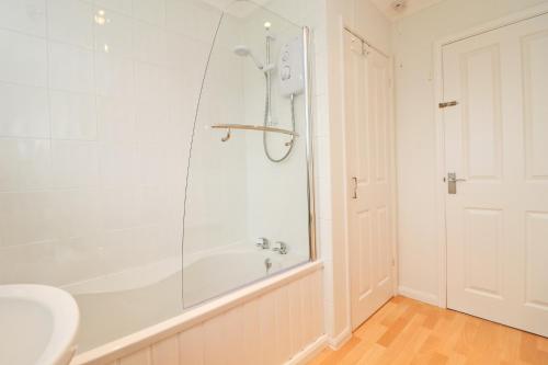 a bathroom with a shower and a tub and a sink at 7 BAYS for 7 DAYS! Spacious bungalow near 7 beaches in St Merryn